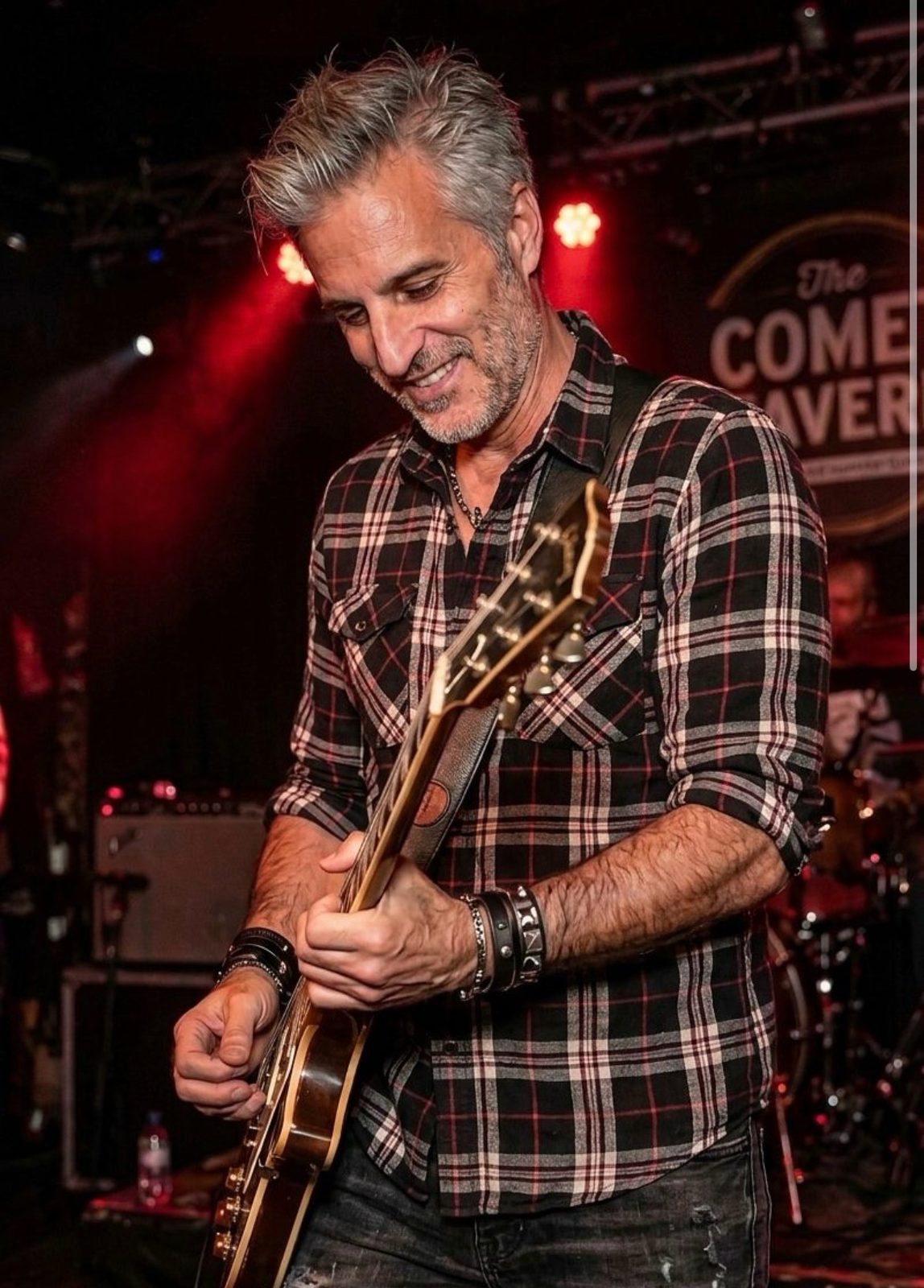 Dan on stage with a guitar